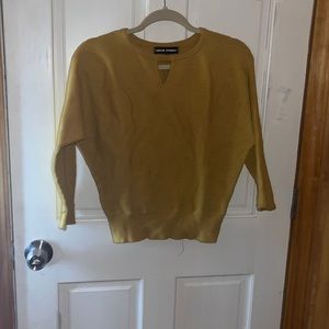 Yellow knitted sweater with triangle cut out on top